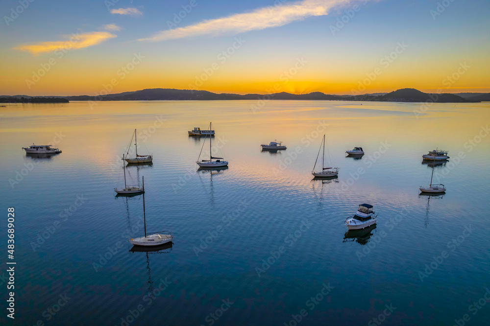 Fototapeta premium Aerial sunrise waterscape with boats