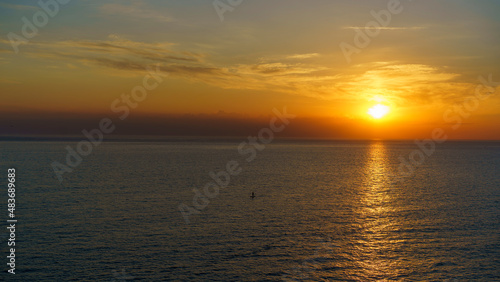 Seascape with a beautiful sunset over the water surface. © vvicca