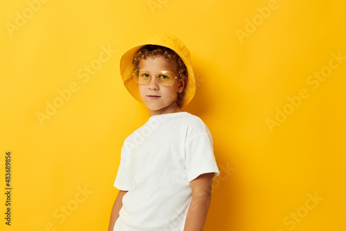cute boy in yellow panama wearing glasses posing fashion
