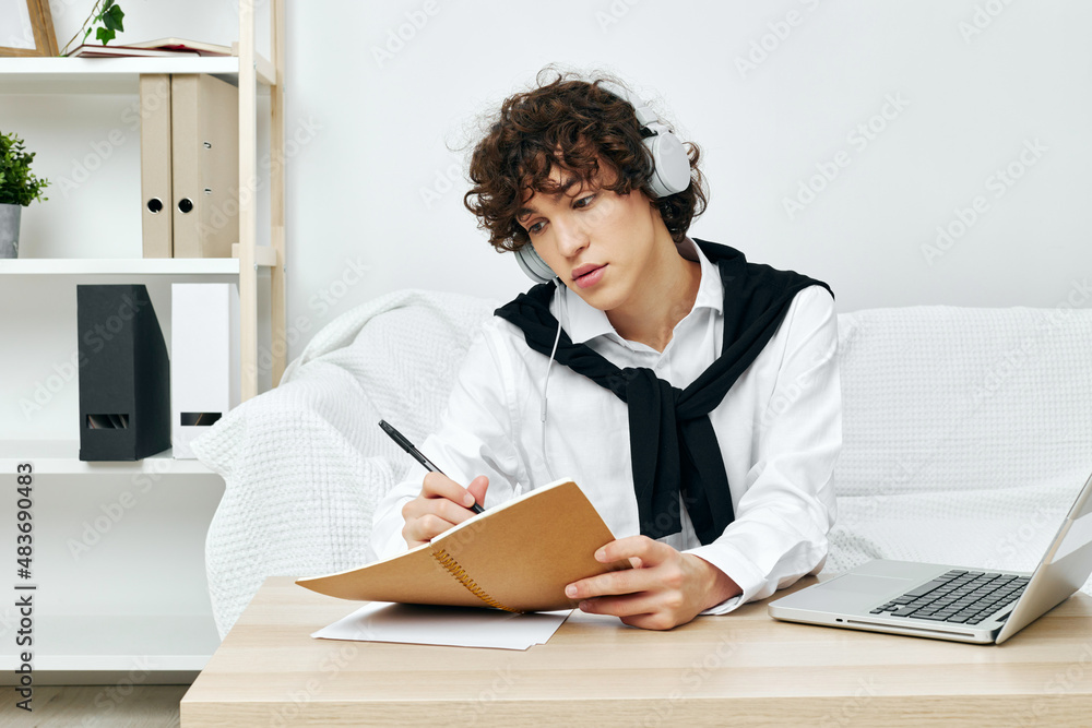 teenager laptop in headphones on white sofa communication teenager laptop in headphones on white sofa communication