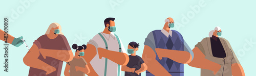 doctor hand vaccinating multi generation family patients in medical mask fight against coronavirus vaccine development