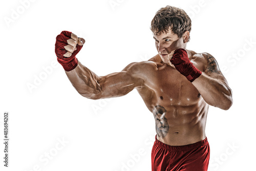 Portrait of male boxer who training and practicing right hook on white background. Red sportswear