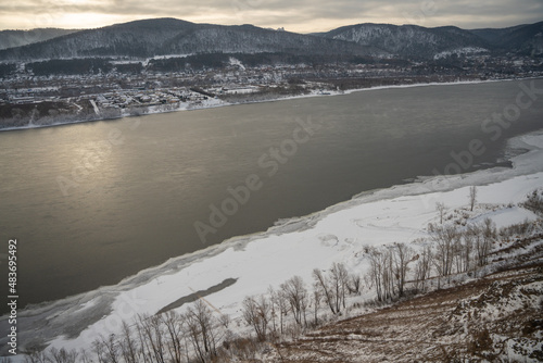 Awesome winter landscape. Top view of the Yenisey River among scenic mountains, Siberia.