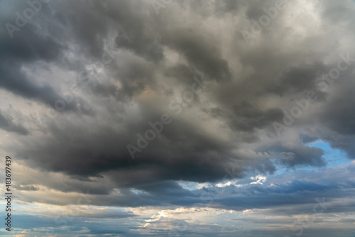 Dark storm clouds on the blue sky