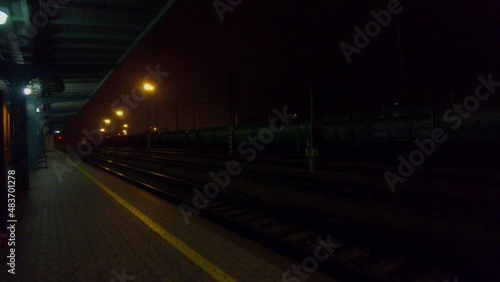 Abandoned train station in the dark and lamp lights, standing train nearby. Česká Třebová, Czech Republic