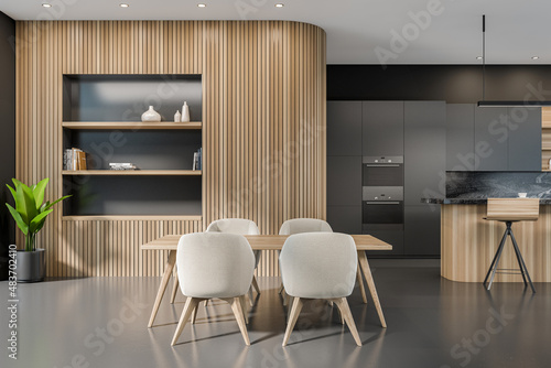 Dark kitchen room interior with double oven  dining table