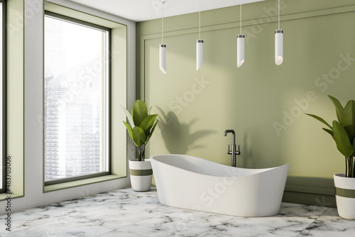 Fotografering Green bathroom interior with bathtub on tile marble floor, panoramic window