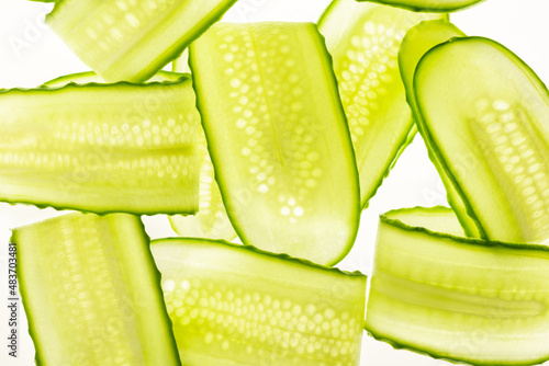 Beautiful fresh transparent cucumber slices on white background