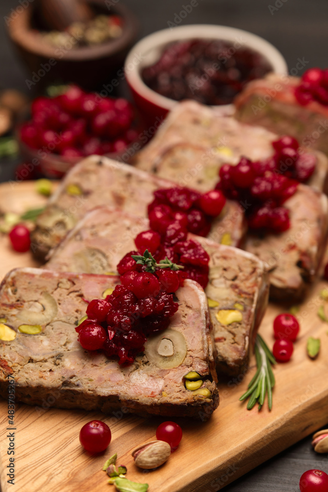Sliced Traditional French terrine covered with bacon on dark wooden background Sliced Traditional French terrine covered with bacon on dark wooden background
