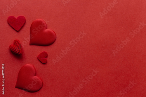 Red background with red hearts and ribbon. St. Valentine day card.