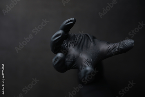 Fototapeta Naklejka Na Ścianę i Meble -  Background of hands in gloves. Black gloves. Hand gestures in black gloves.