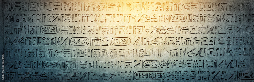 Old Egyptian hieroglyphs on an ancient background. Wide historical background. Ancient Egyptian hieroglyphs as a symbol of the history of the Earth.