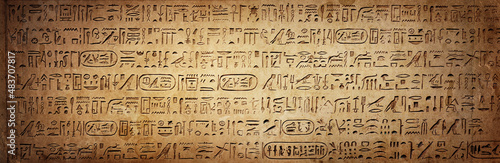 Old Egyptian hieroglyphs on an ancient background. Wide historical background. Ancient Egyptian hieroglyphs as a symbol of the history of the Earth. photo