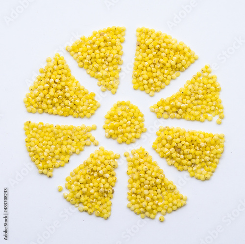 millet groats on a white background, millet porridge, snowflake from millet grains, flower from cereals