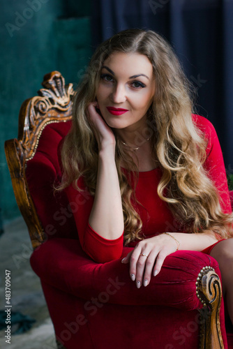 portrait of a young woman in a red dress with red lips