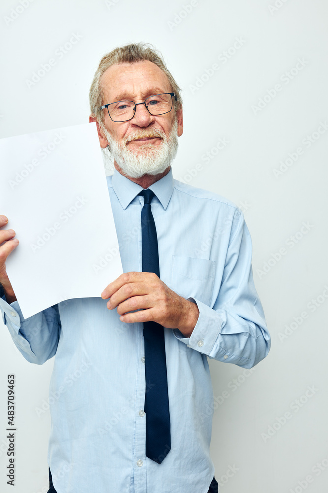 old man holding documents with a sheet of paper light background old man holding documents with a sheet of paper light background