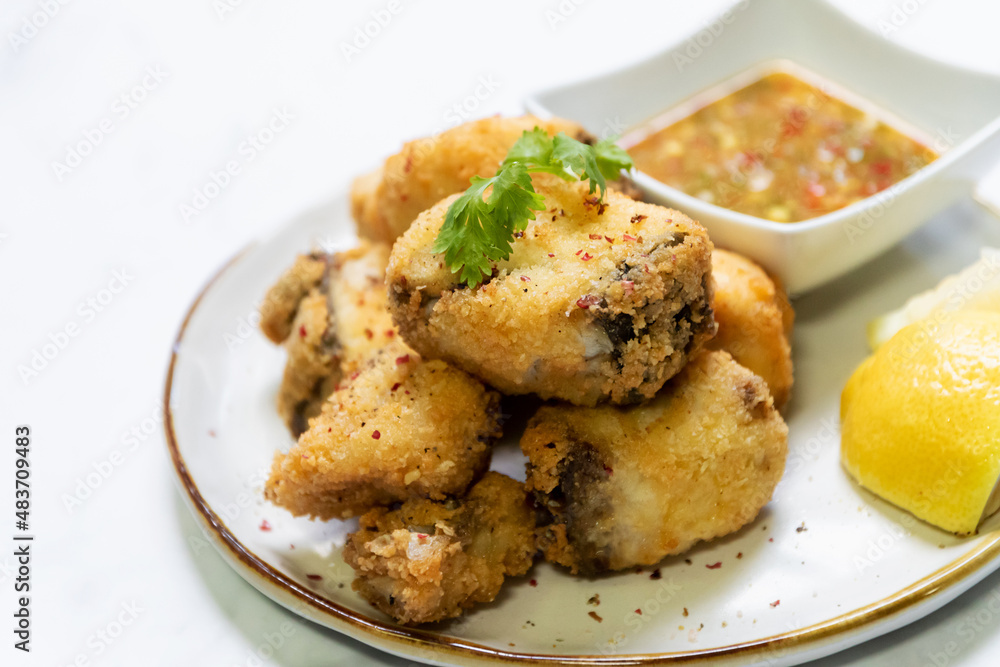 Crispy fried fish sea bass fillets served on plate. Crispy fried fish sea bass fillets served on plate.