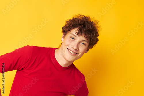 Young curly-haired man summer style fashion posing isolated background unaltered © Tatiana