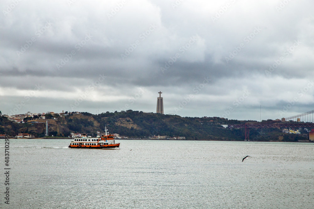 Lisboa Tago River panorama with boat and lighthouse. Lisbon, Portugal