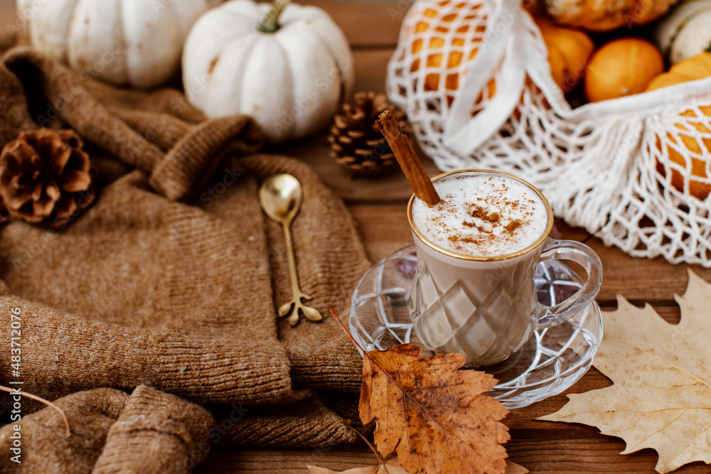 Cup of Pumpkin Spice Latte and Fall Decor from fresh pumpkins. Traditional Coffee Drink for Autumn Holidays, cozy, hygge, comfortable Cup of Pumpkin Spice Latte and Fall Decor from fresh pumpkins. Traditional Coffee Drink for Autumn Holidays, cozy, hygge, comfortable