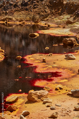 Lago rojo formado en cantera abandonada photo