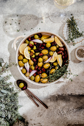 Roasted olives and lemons with herbs. photo