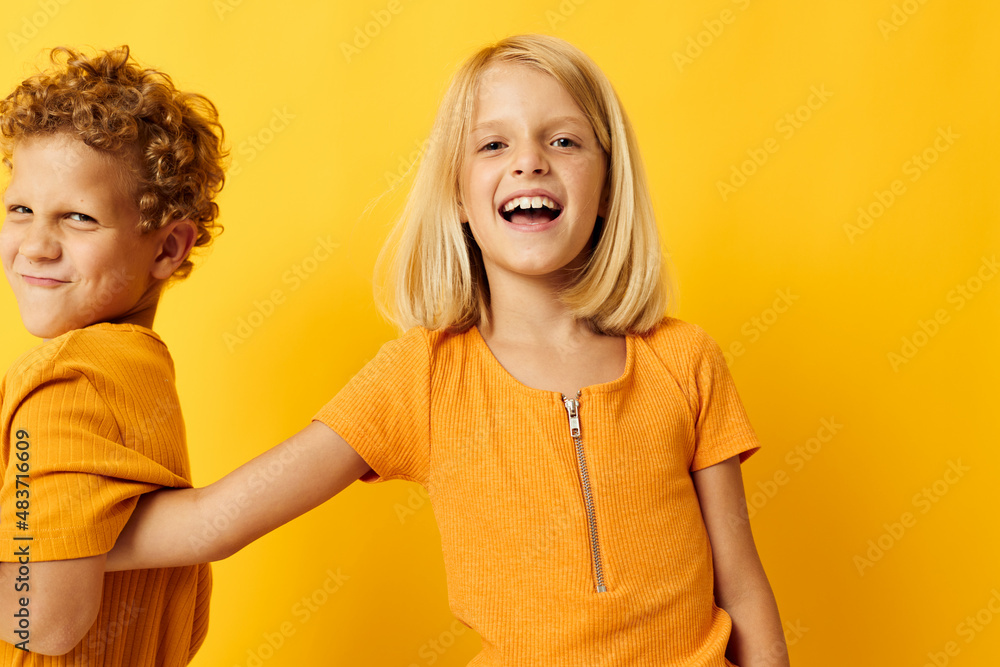 picture of positive boy and girl cuddling fashion childhood entertainment on colored background picture of positive boy and girl cuddling fashion childhood entertainment on colored background