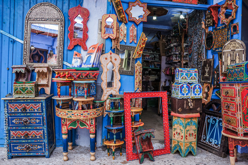 a front of Moroccan market shop with colorful home decoration elements and furniture