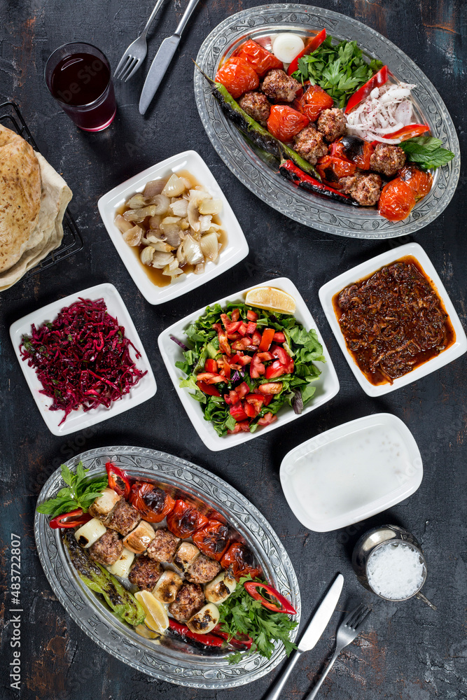 turkish onion kebab, salad, lavash, buttermilk , appetizers on the dark bacground turkish onion kebab, salad, lavash, buttermilk , appetizers on the dark bacground