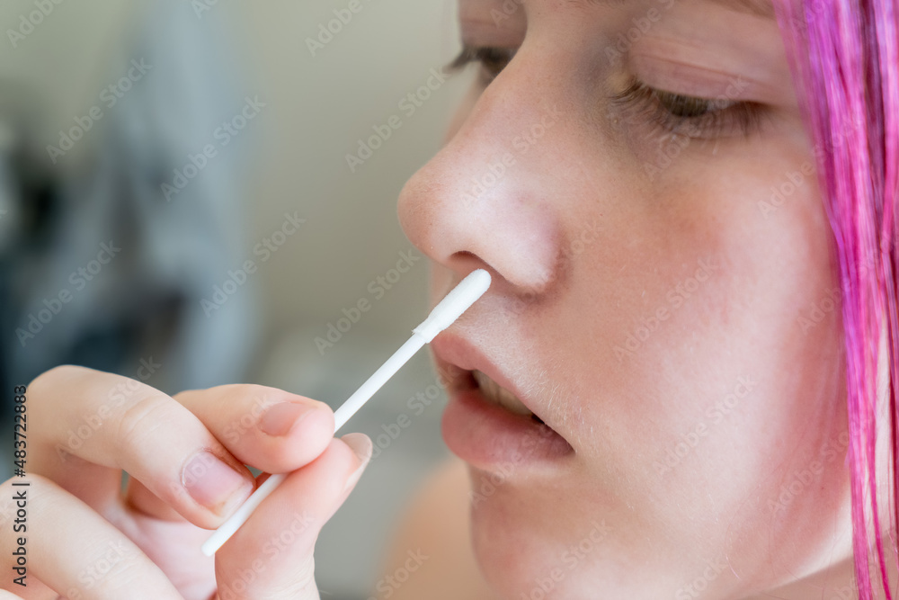 Teenage girl doing rapid antigen test nasal swab. Free rapid diagnostic tests for student back to school in NSW Australia Teenage girl doing rapid antigen test nasal swab. Free rapid diagnostic tests for student back to school in NSW Australia