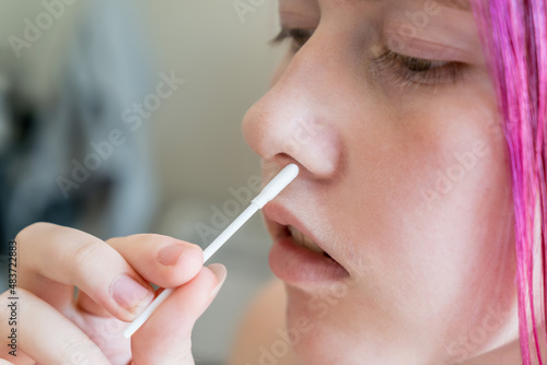 Teenage girl doing rapid antigen test nasal swab. Free rapid diagnostic tests for student back to school in NSW Australia