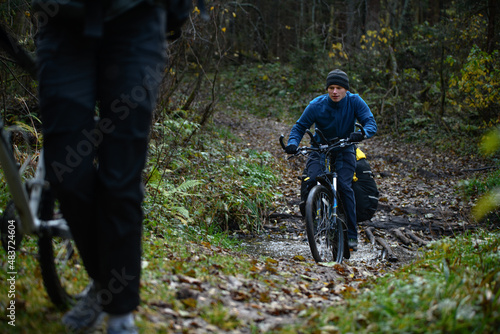 Russian bicyclist in the autumn forest, Moscow Region