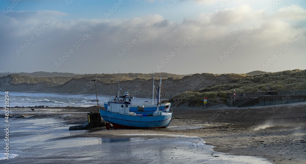 traditional fisher boats on the beach in northern Denmark in norre vorupor on a stormy day