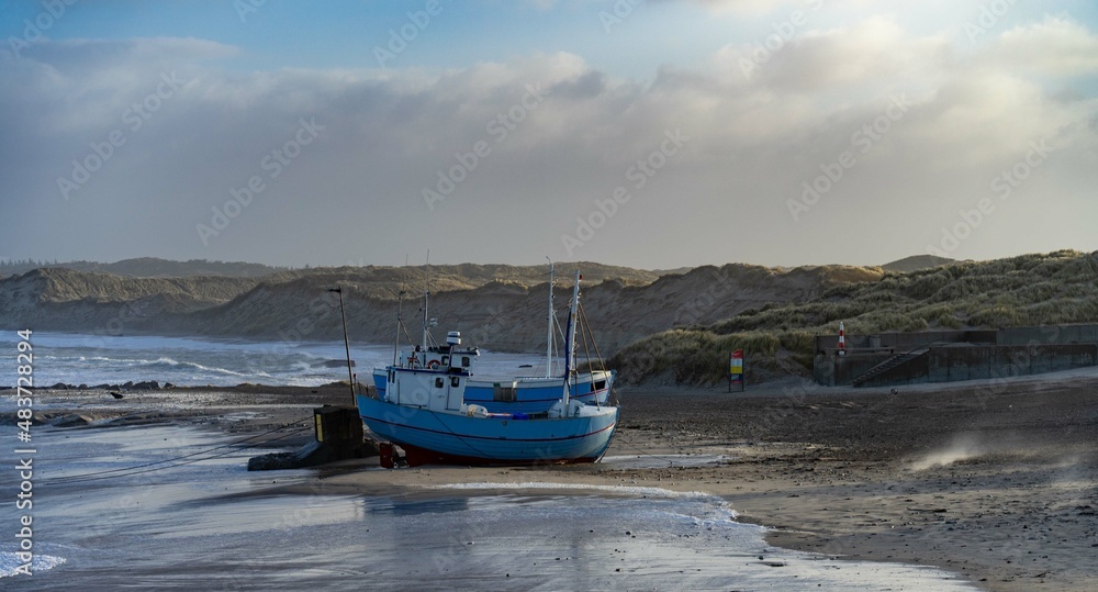 traditional fisher boats on the beach in northern Denmark in norre vorupor on a stormy day traditional fisher boats on the beach in northern Denmark in norre vorupor on a stormy day