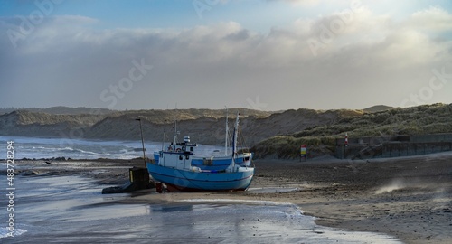 traditional fisher boats on the beach in northern Denmark in norre vorupor on a stormy day