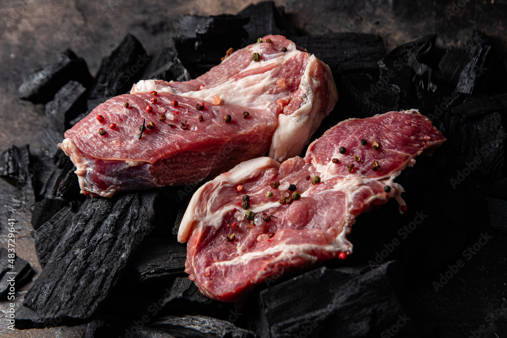Raw pork steak on a plain background. Raw meat
