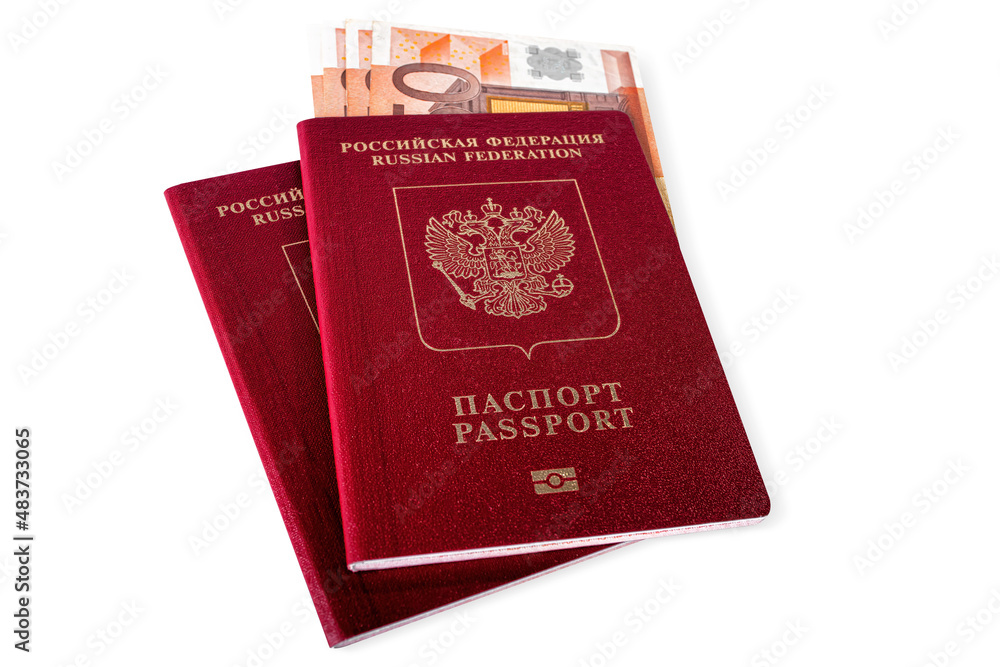 A couple of red Russian passports for travel, going abroad with bunch of euros banknotes inside, isolated. A couple of red Russian passports for travel, going abroad with bunch of euros banknotes inside, isolated.