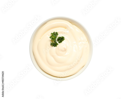 Bowl of tasty mayonnaise with parsley isolated on white, top view