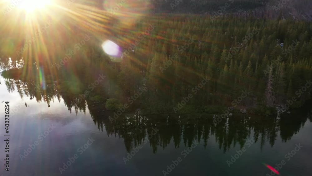 Aerial view of a mountain lake surrounded by a pine trees forest, at sunrise. Mammoth Lakes, CA. Aerial view of a mountain lake surrounded by a pine trees forest, at sunrise. Mammoth Lakes, CA.