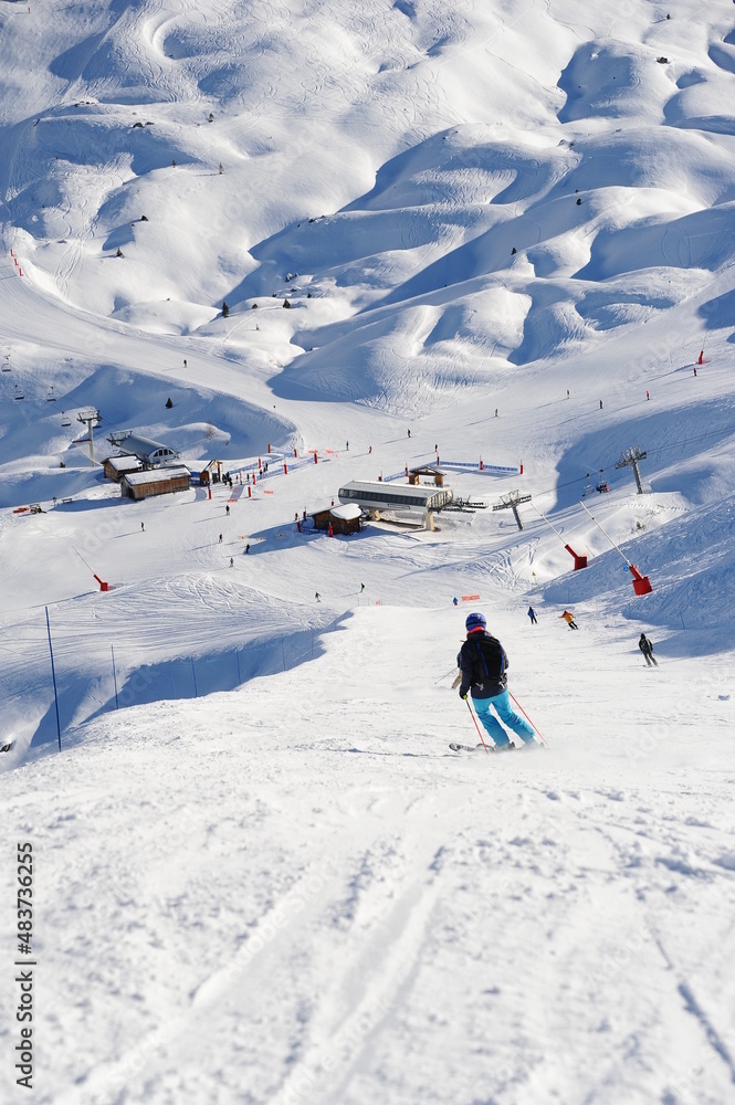 People skiing over the slopes of a ski resort in European alps