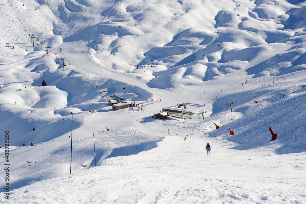 Wide and idyllic  ski slopes of Courchevel ski resort on a sunny day by winter.