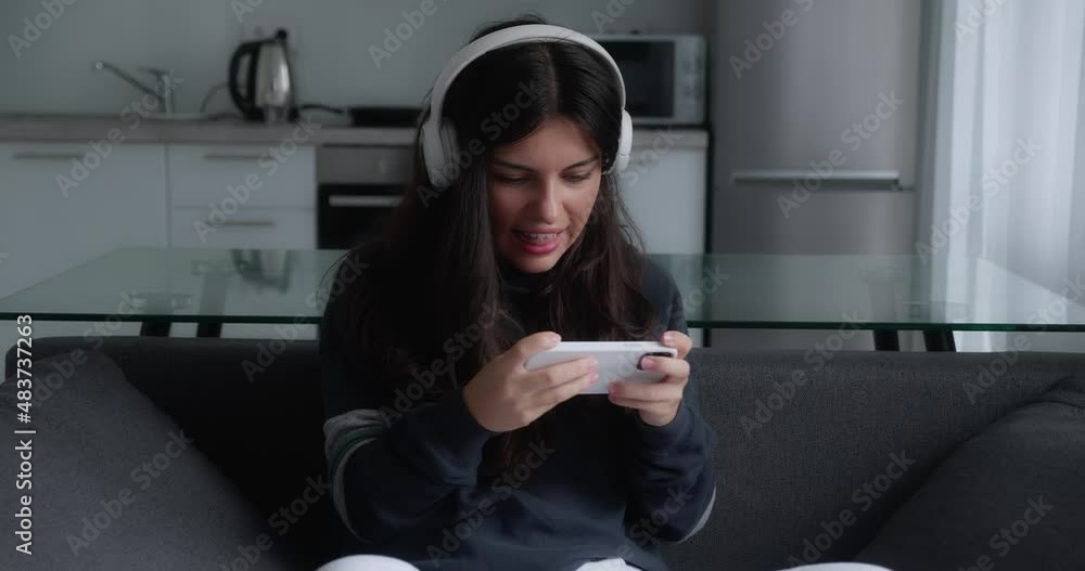Teen playing game in smartphone