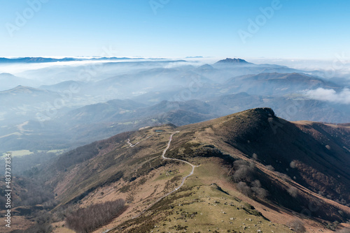 Vista panorâmica desde a montanha de La Rhune no País Basco com montanhas ao fundo com algum nevoeiro nos altos photo