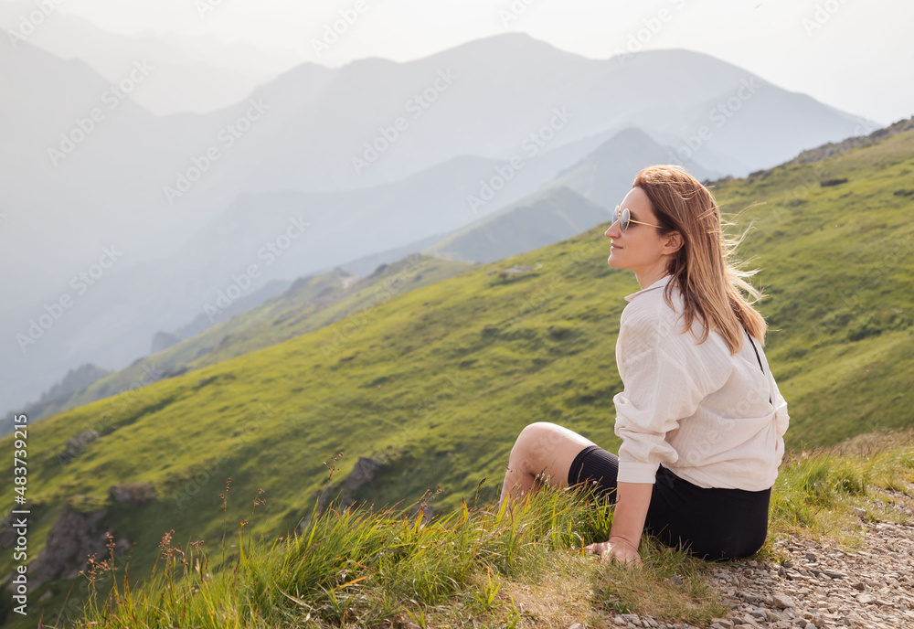 Young woman enjoy view in mountains.