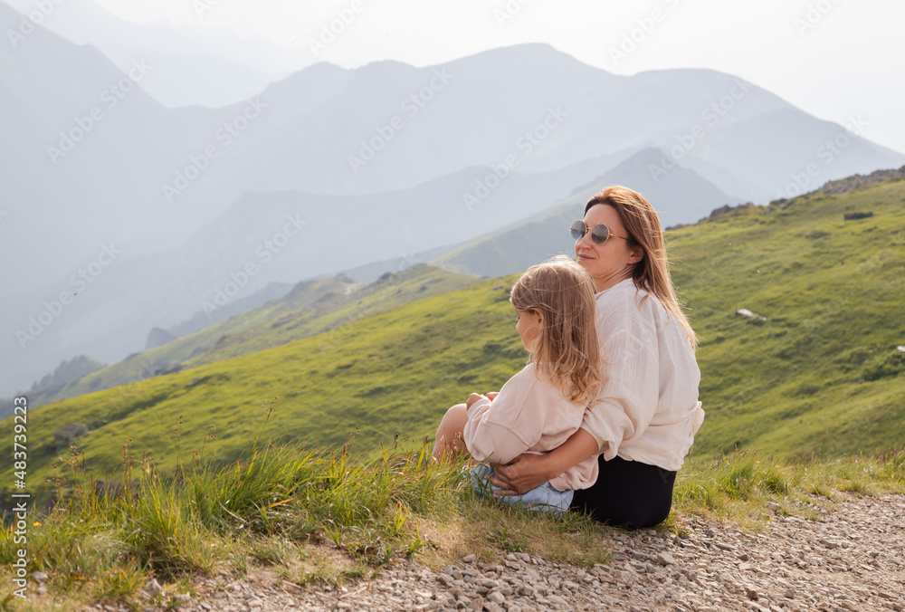 Mother with child toddler enjoy view in mountains.