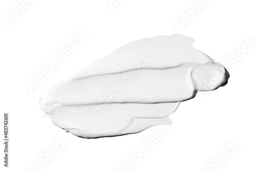 Liquid white cream smear isolated on white background. Beauty cosmetic smudge such as hair conditioner, creamy lotion, facial retinol serum, mask balm, cleanser, shower gel or shampoo top view