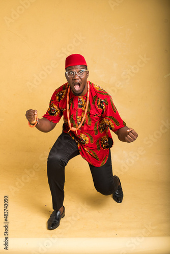 Igbo Traditionally Dressed Business Man in Glasses Winning Stance