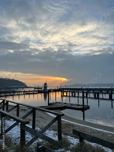 Sunset scene over Baltic sea with empty harbor