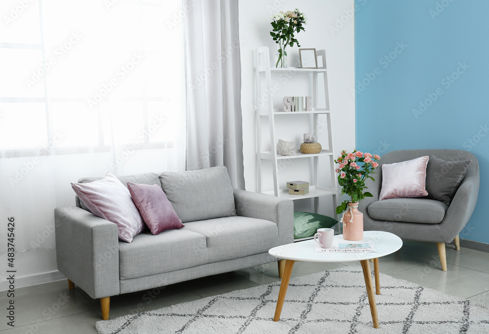 Vase with bouquet of beautiful fresh roses on table in room Vase with bouquet of beautiful fresh roses on table in room