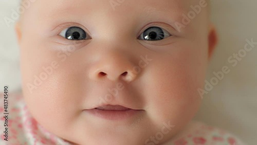 Extreme close up face of cute baby toddler with perfect tender skin and blue eyes